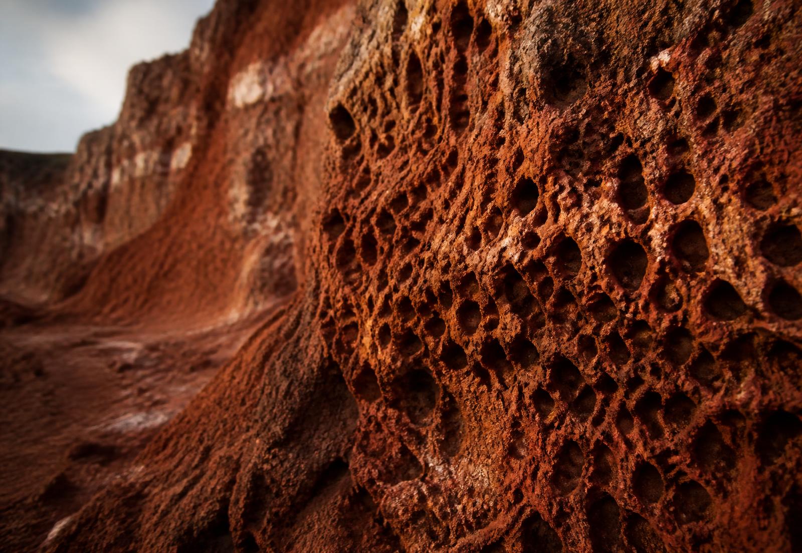 Weathered aluminous laterite rock face with iron-rich texture